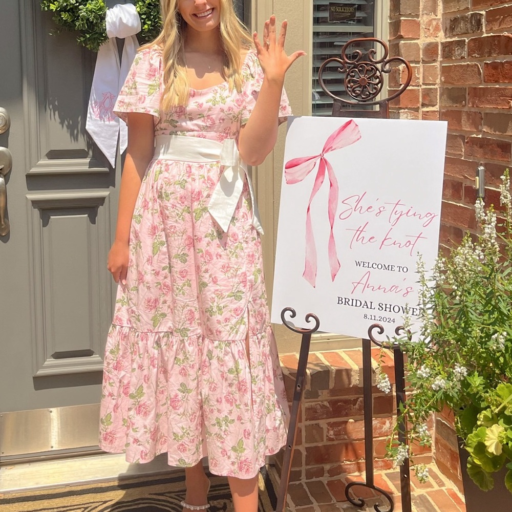 Pink floral dress with white bow sash